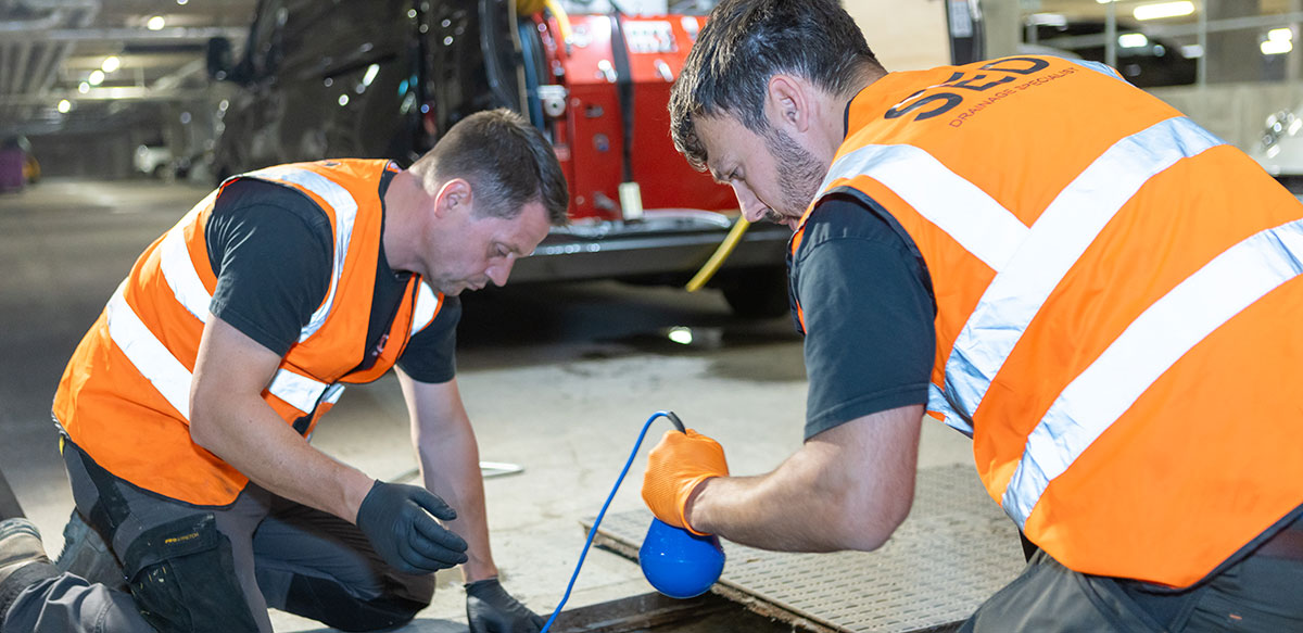 Drain relocation team inspecting site